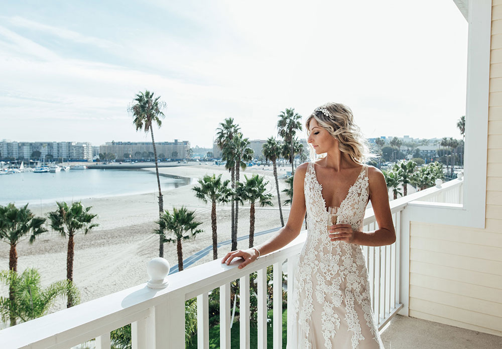 bride on balcony with beach in background