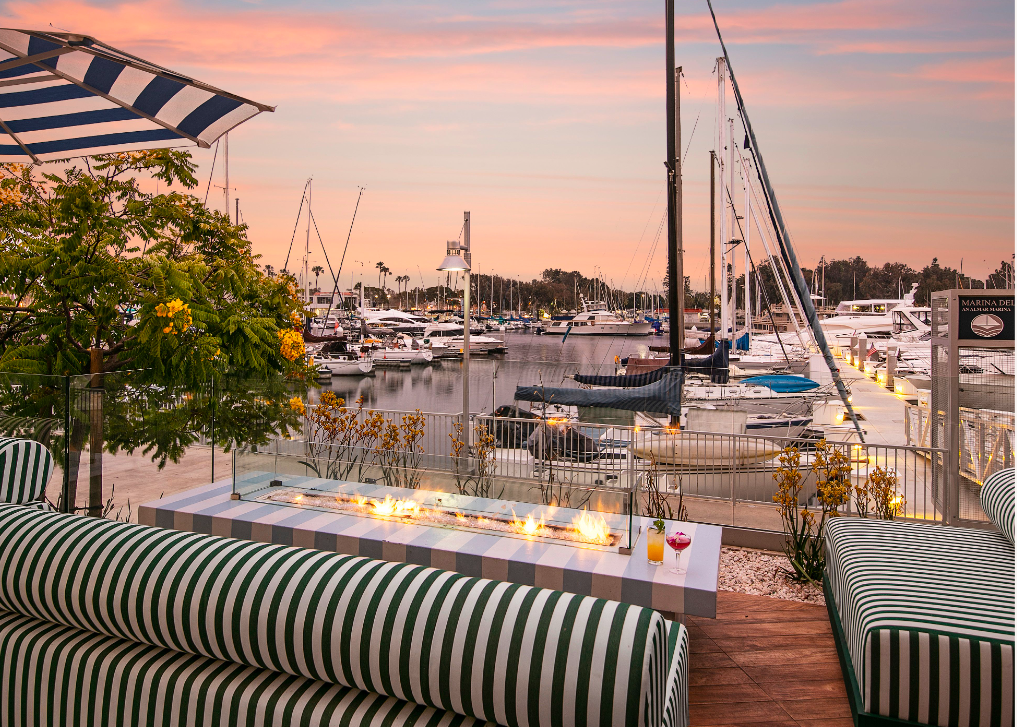 Outdoor fire pit table at SALT Restaurant during sunset in Marina del Rey Hotel