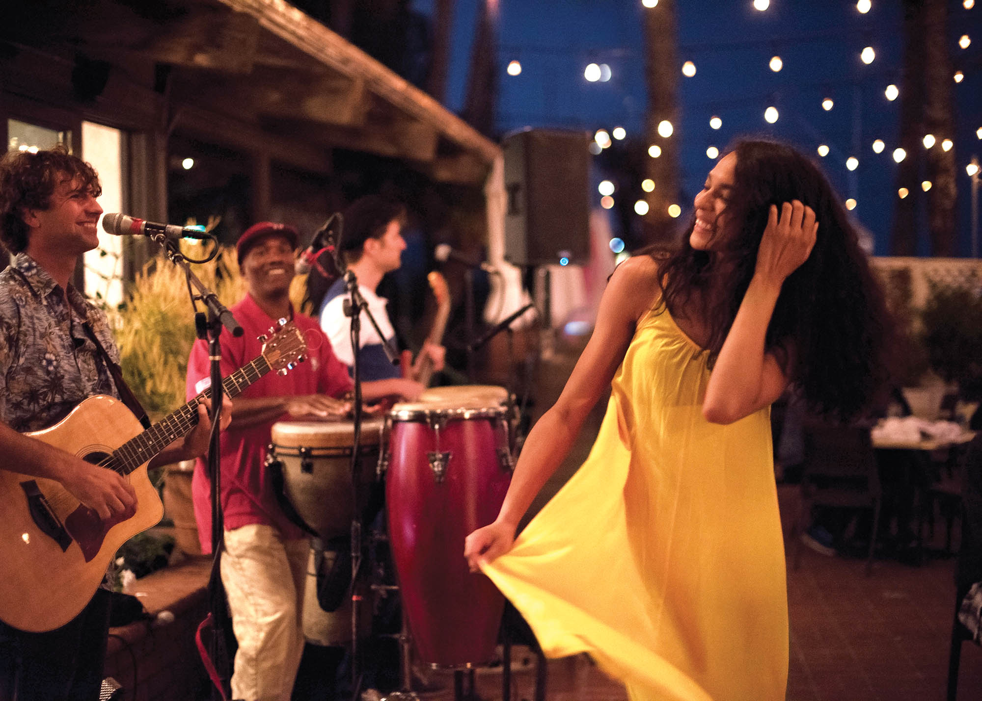 woman dancing in front of band at night