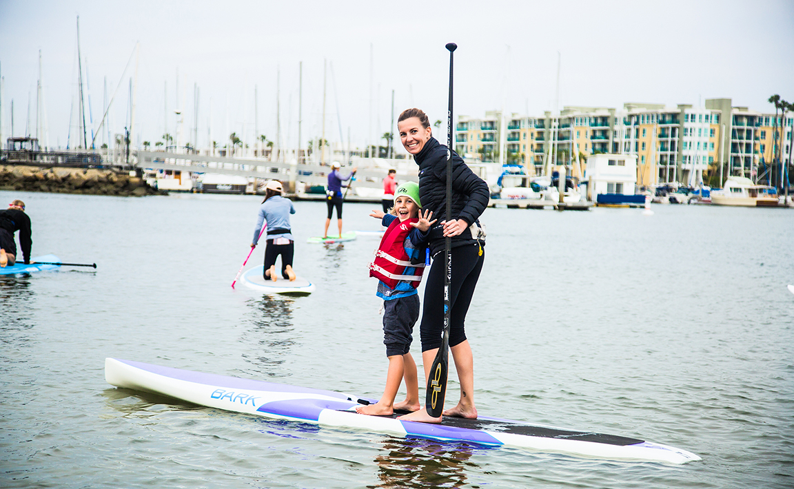 Mom with young child on the paddle board