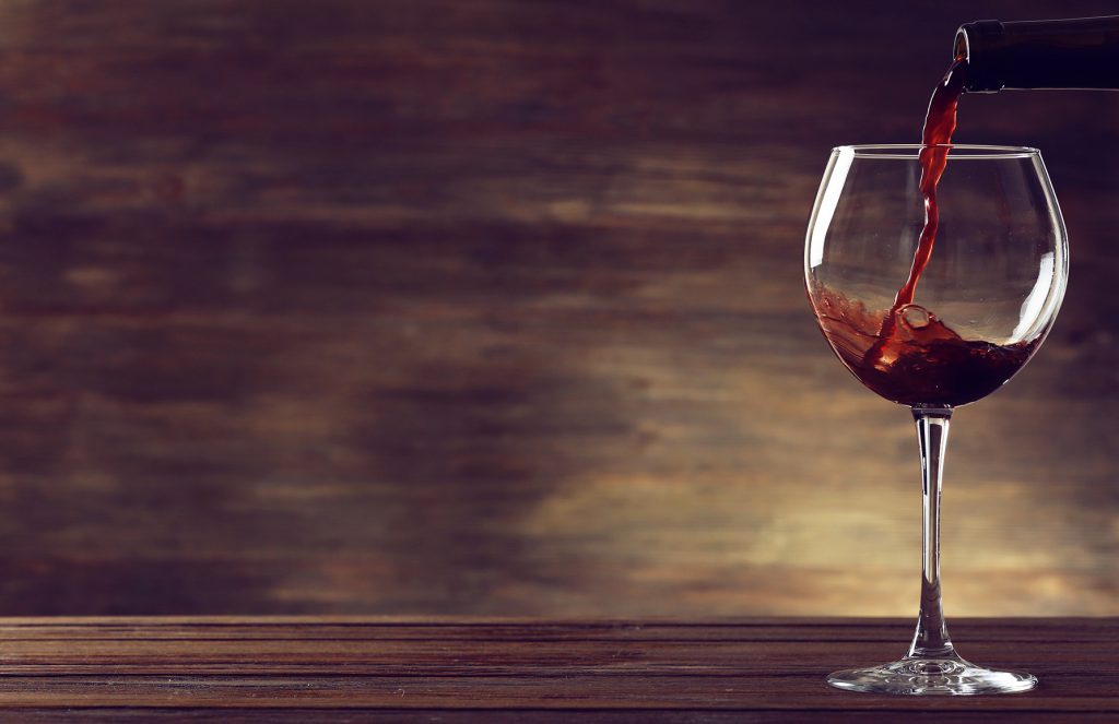 Red wine pouring in a glass