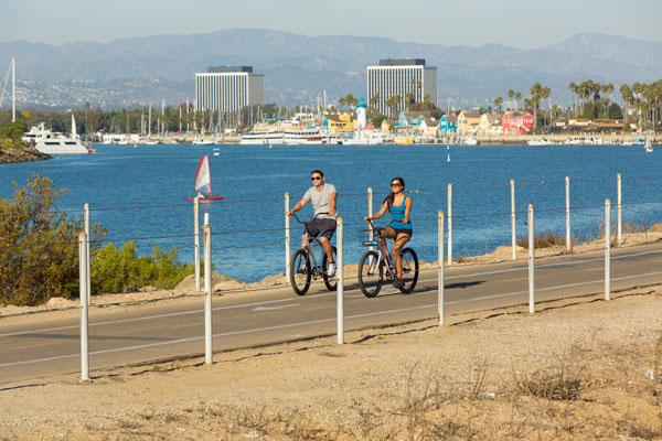couple enjoying biking at the beach