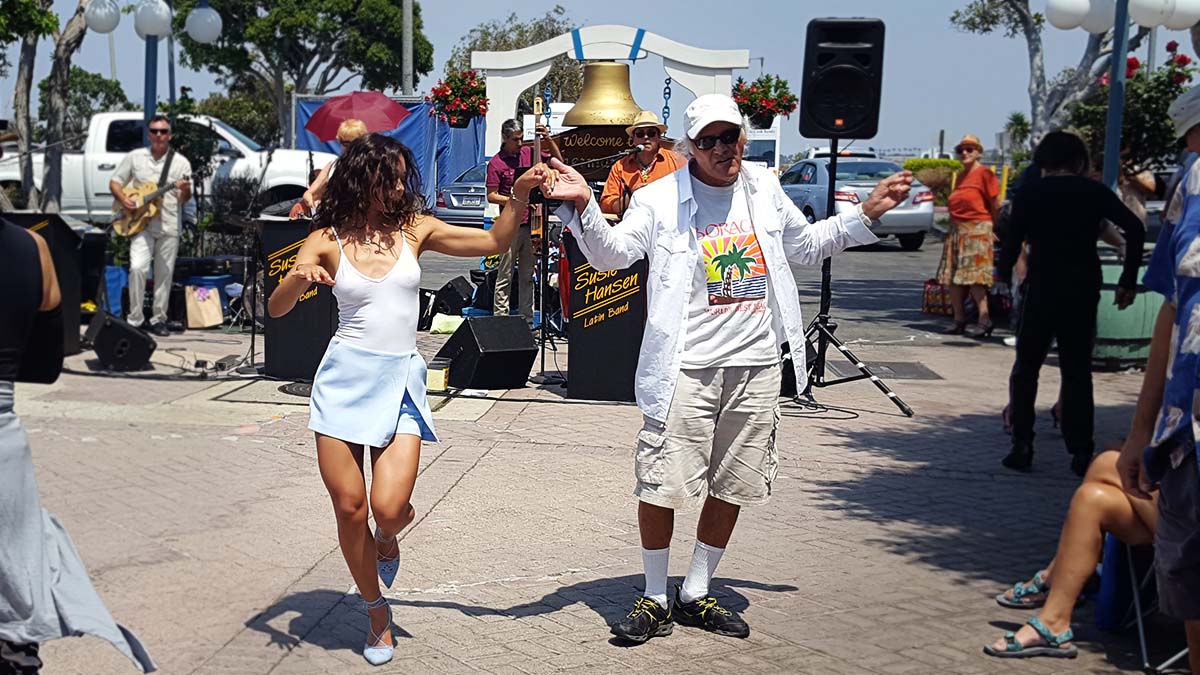 couple dancing in front of band in fisherman's village