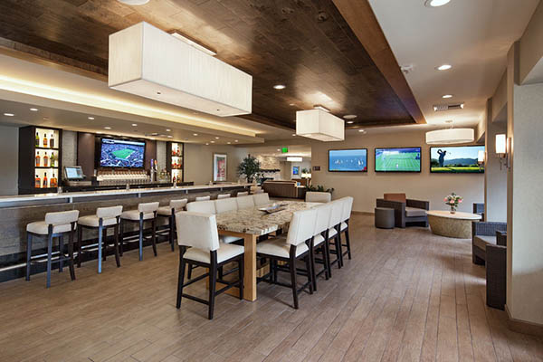 dining area of lounge with TVs on the walls