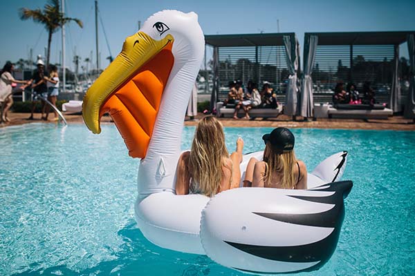 women on a pelican pool float