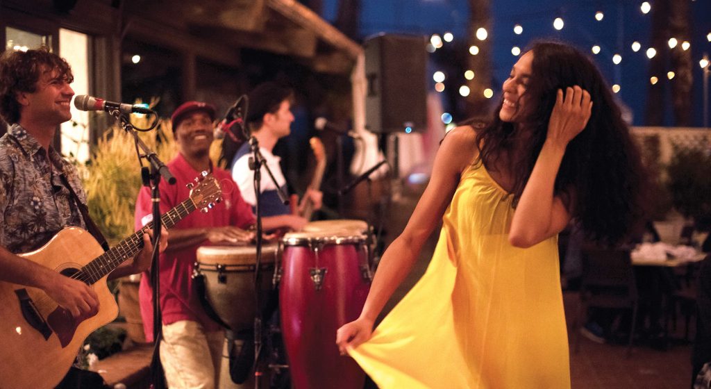 woman dancing in front of band at night
