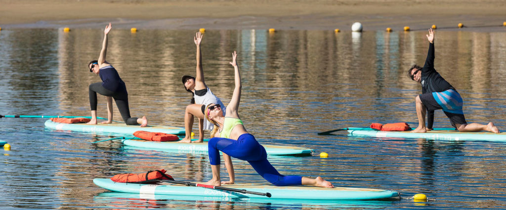 group yoga class on paddle boards in marina del rey