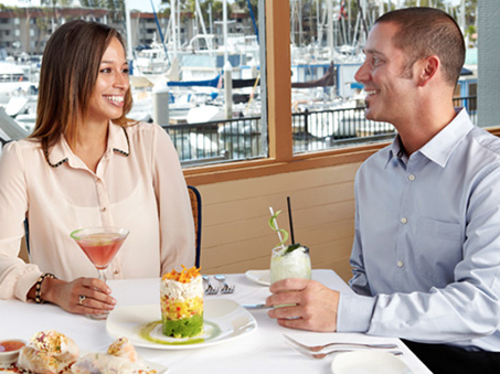 Couple dining at the waterfront Chart House restaurant in Marina del Rey