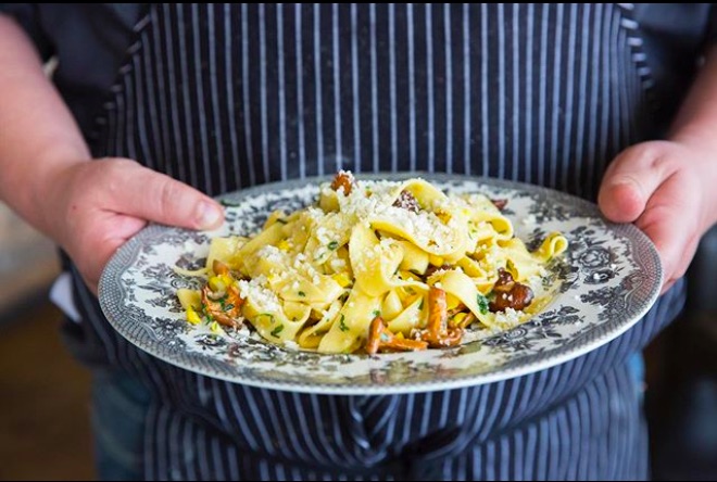 Chef holding plate with pasta in Terzo Newly Opened Marina del Rey Restaurant
