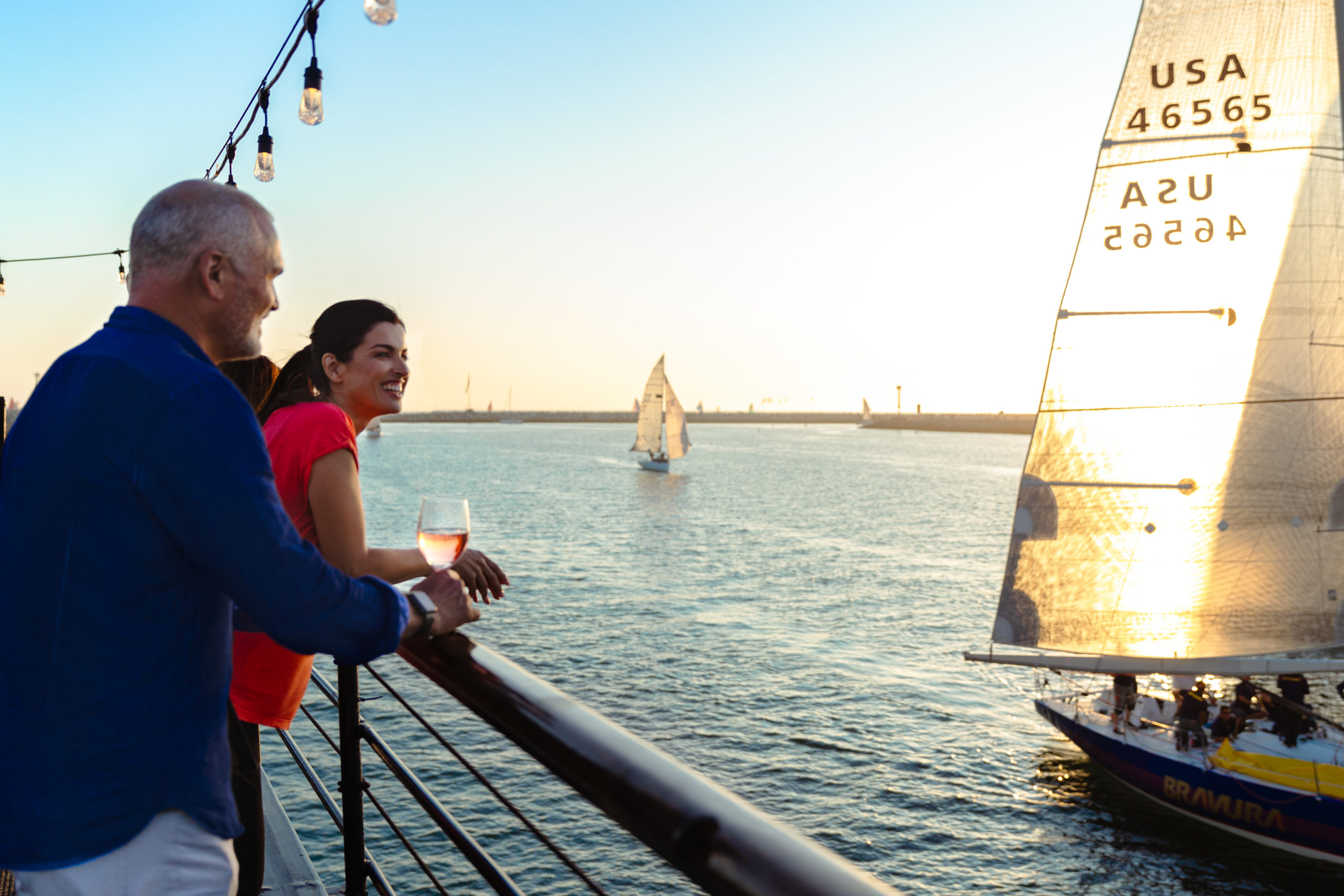Couple enjoying sunset on top deck of dining cruise in Marina del Rey harbor