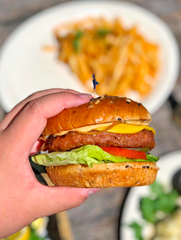 hand holding vegan burger for marina del rey takeout