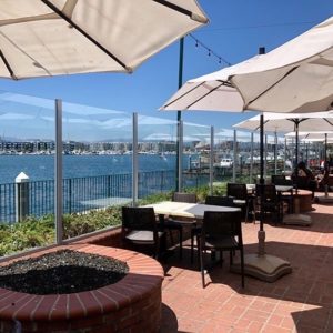 Outdoor patio tables and umbrellas with waterfront view