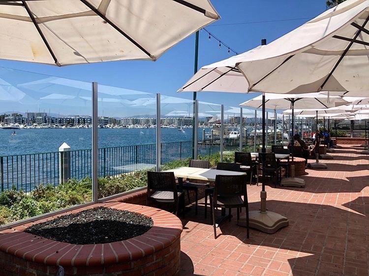 Outdoor patio tables and umbrellas with waterfront view