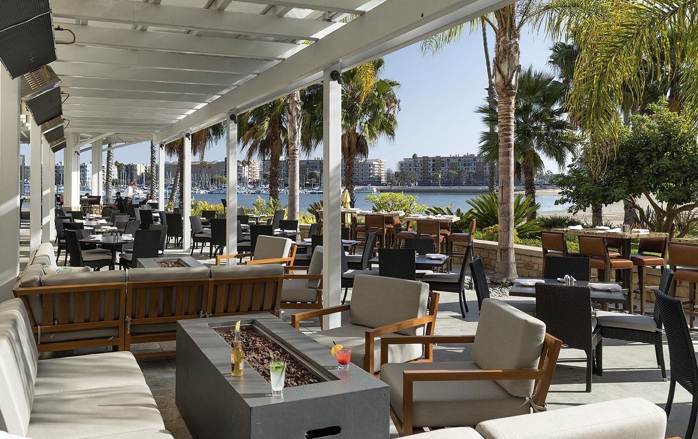 Outdoor dining patio at Beachside restaurant with view of Marina "Mother's" Beach