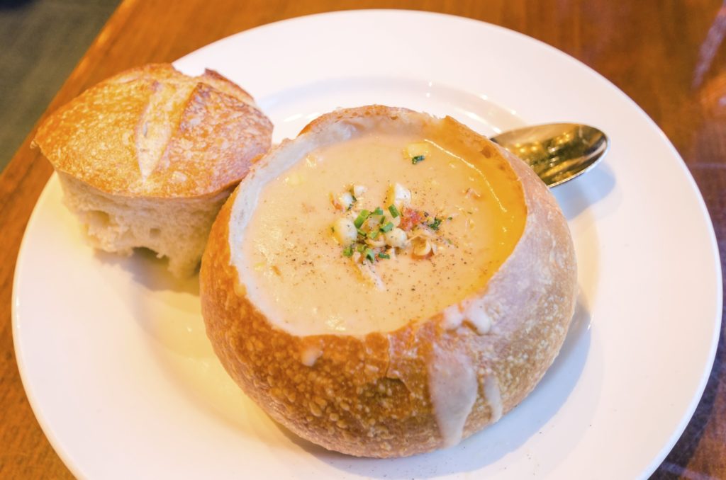 Clam chowder in a bread bowl on a plate