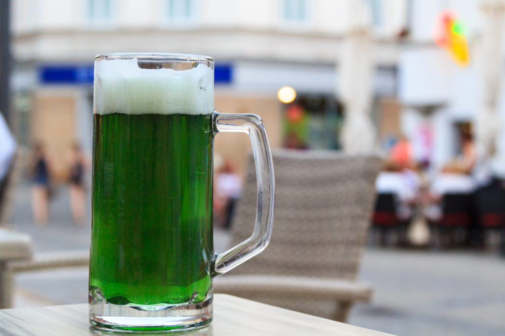 Green beer in a mug outside at a restaurant