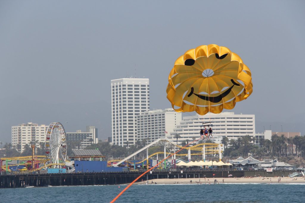 parasailing above Pacific Ocean near Santa Monica Pier