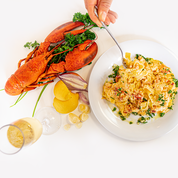 lobster next to lobster pasta in a dish