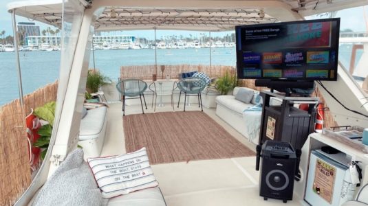 Inside of private boat with seating and large screen television
