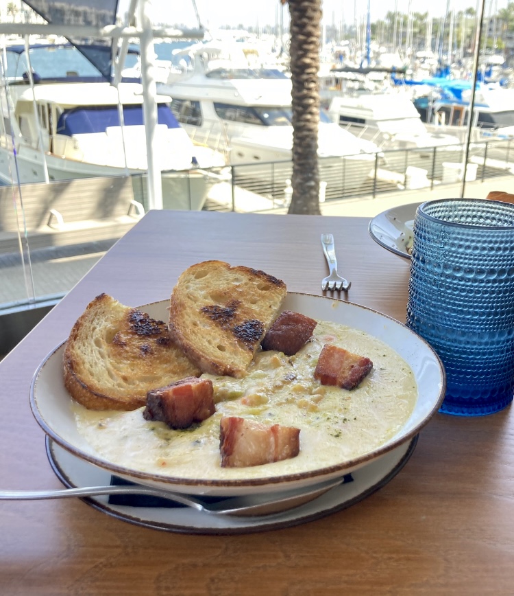 bowl of clam chowder on restaurant patio table