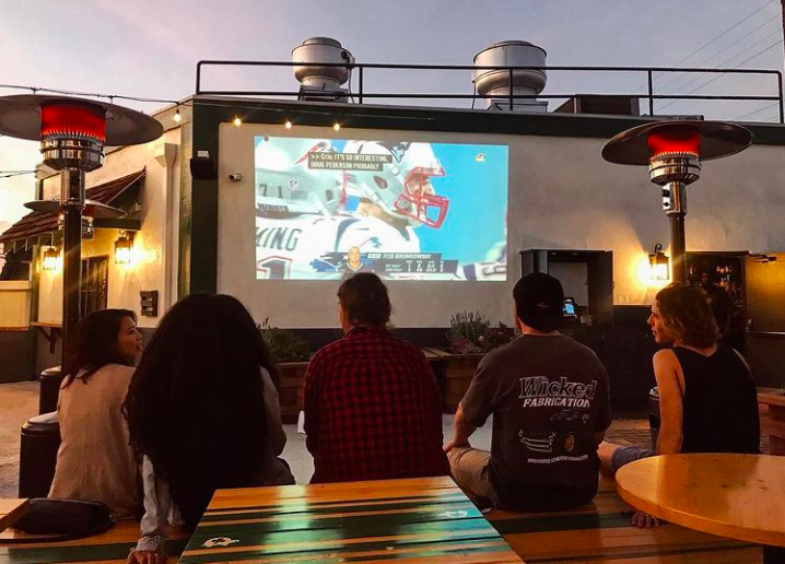People watching Super Bowl in MDR on outdoor screen