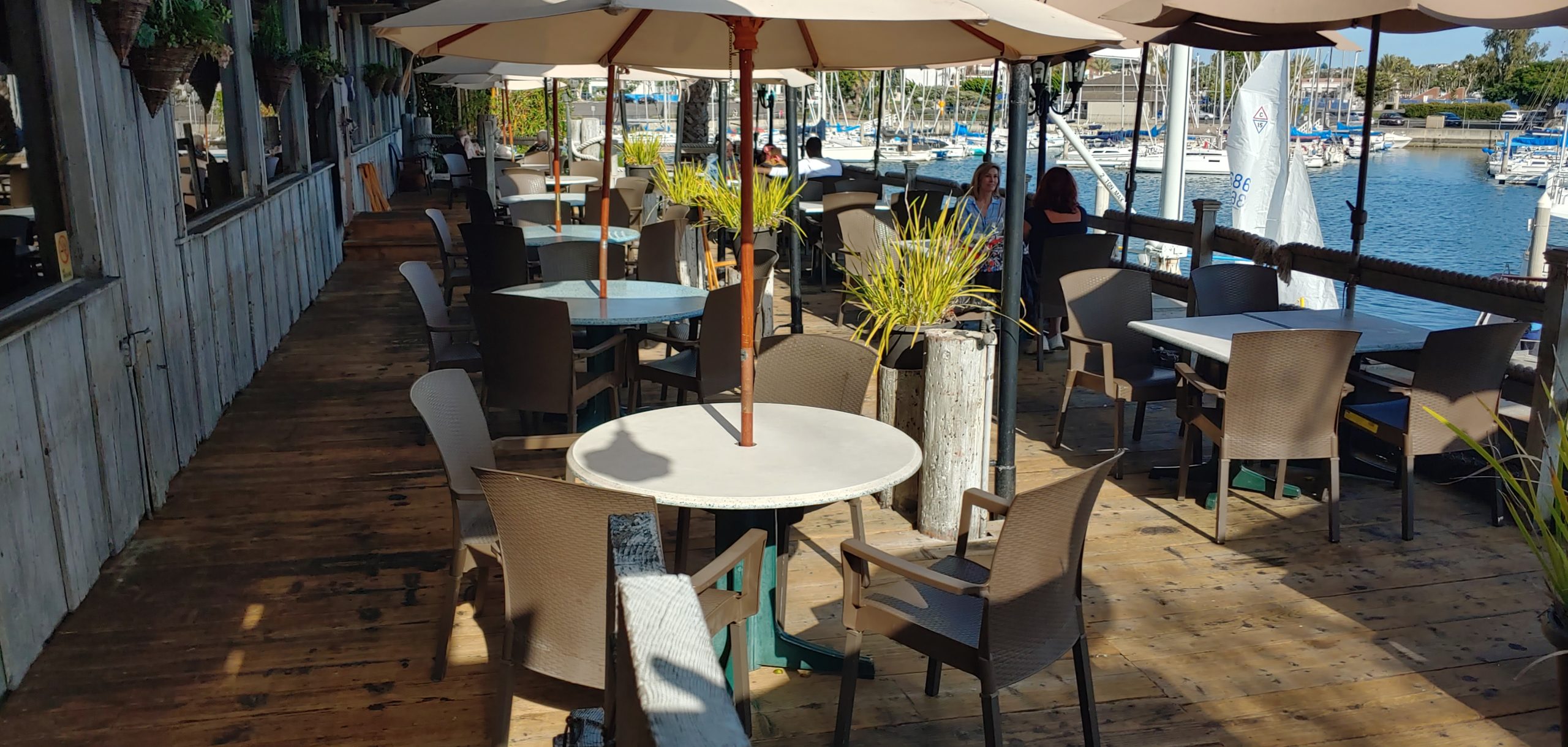 outdoor patio at waterfront restaurant with tables and chairs
