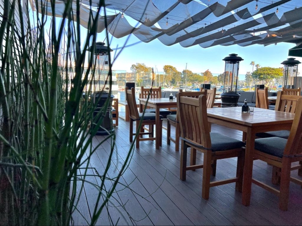 Outdoor patio restaurant facing harbor