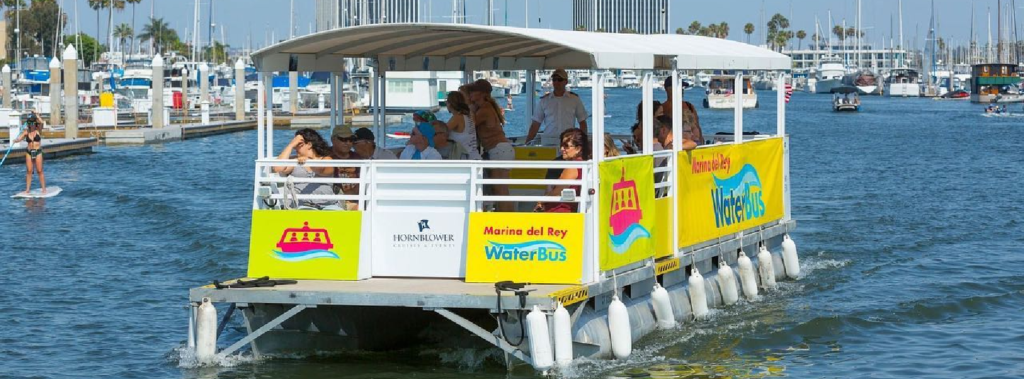 people riding open air pontoon Marina WaterBus in the harbor