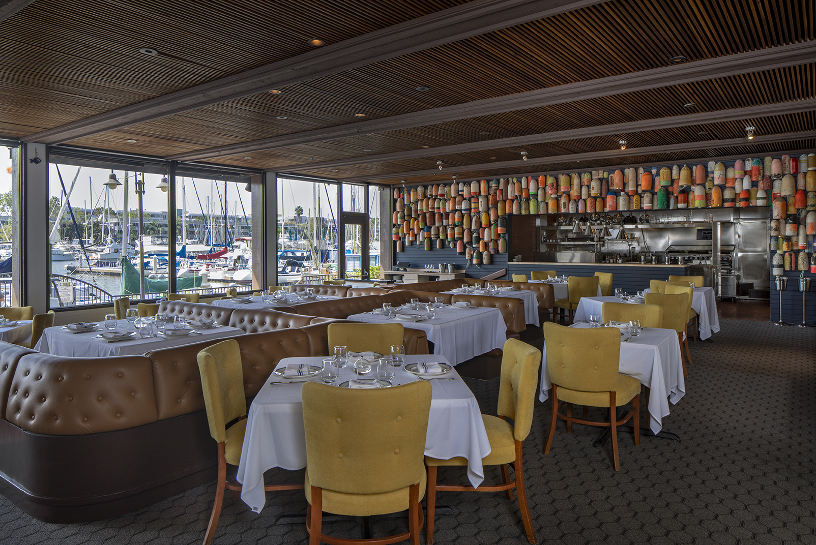 indoor restaurant dining room with views of harbor and boats
