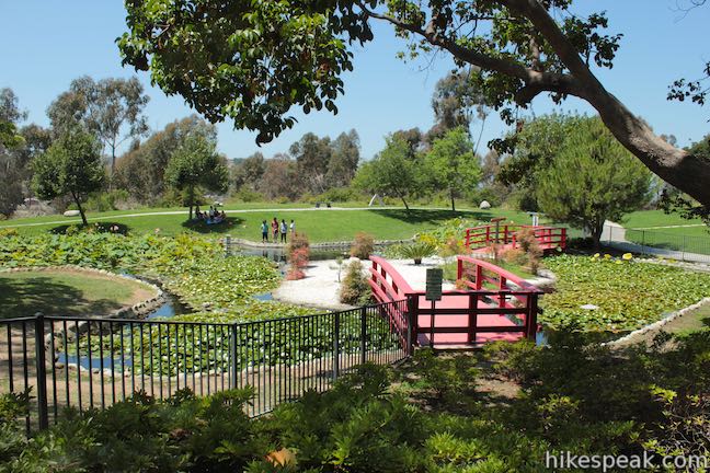 japanese gardens with red bridges, grass and trees at kenneth hahn state park