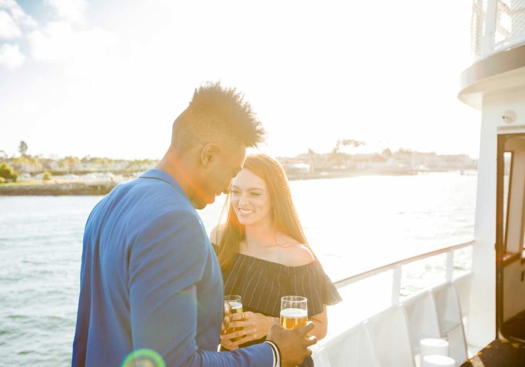 Couple on deck overlooking water for Valentine's Day dinner cruise