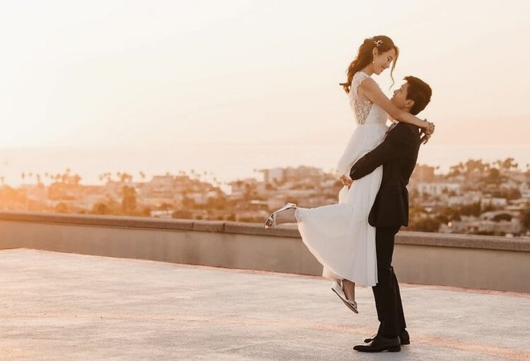 Wedding couple on rooftop of Marina del Rey Marriott hotel overlooking mountain and ocean view