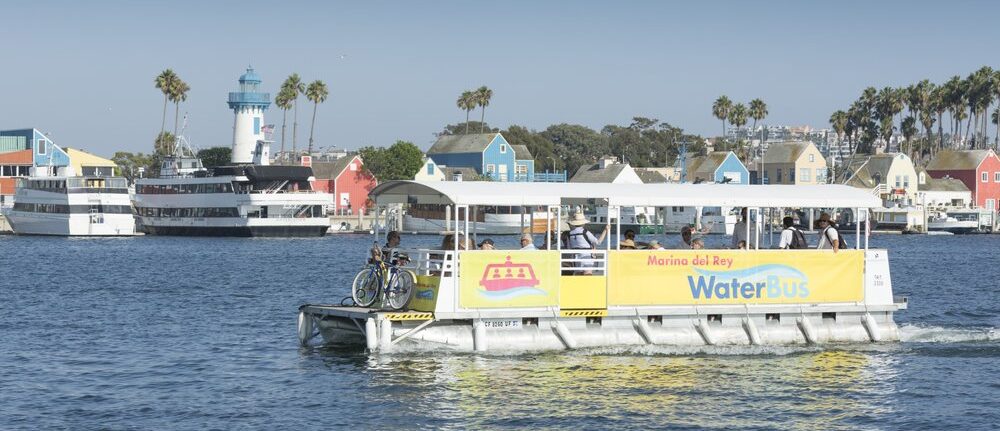 Explore Marina del Rey by riding yellow open-air water pontoon throughout the harbor